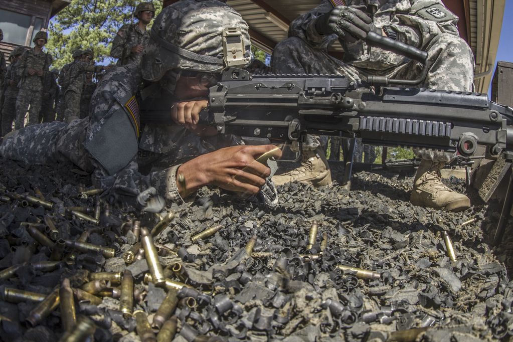 Proyectil de 5.56 mm. Un soldado dispara con cartuchos de la OTAN.