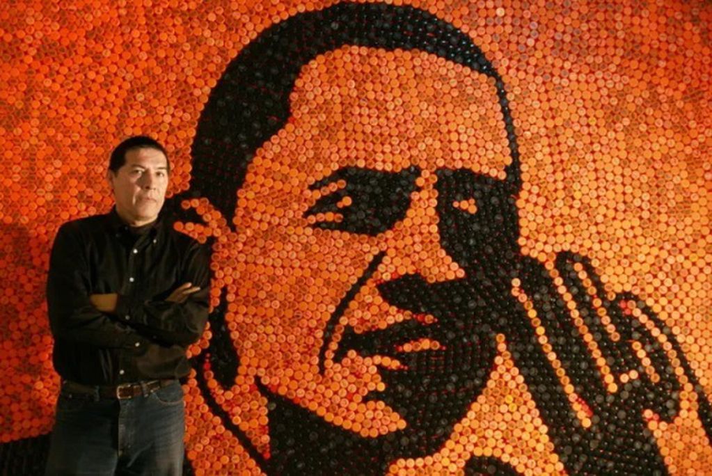 Murillo junto a una de sus obras realizadas con tapas de gaseosas. Gentileza