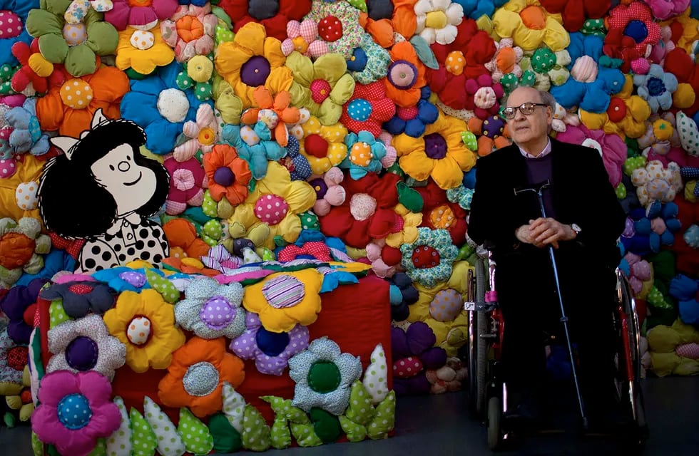 En esta foto del 15 de septiembre de 2014, el caricaturista argentino Joaquín Salvador Lavado, "Quino", posa junto a su personaje de Mafalda en la exposición "El mundo según Mafalda", en Buenos Aires.
