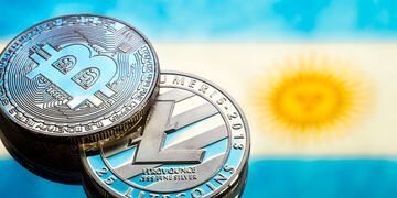 coins Bitcoin and litecoin, against the background of Argentina flag, concept of virtual money, close-up. Conceptual image.