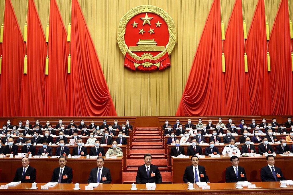 In this photo released by Xinhua News Agency, Chinese President Xi Jinping, center, attends the opening session of China's National People's Congress (NPC) at the Great Hall of the People in Beijing,