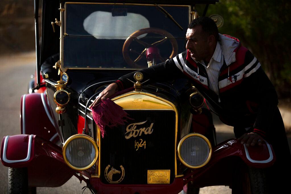 Un mecánico limpia un Ford T de 1924 el martes 1 de marzo de 2022, en Obour, cerca de El Cairo, Egipto. El vehículo perteneció alguna vez al rey Farouk de Egipto y forma parte de más de 250 coches vintage, antiguos y clásicos que el empresario Mohamed Wahdan ha coleccionado durante los últimos 20 años. (AP Foto/Amr Nabil)