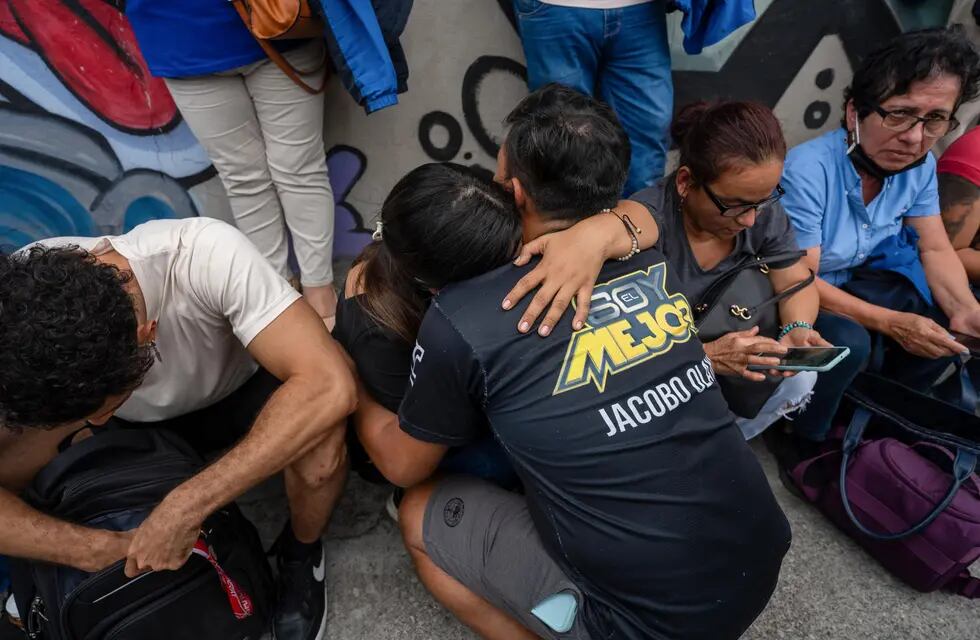 Trabajadores del canal de televisión TC se lamentan hoy a las afueras de la sede, en la que donde encapuchados armados ingresaron y sometieron a su personal durante una transmisión en vivo, en Guayaquil (Ecuador). Foto: EFE/Mauricio Torres