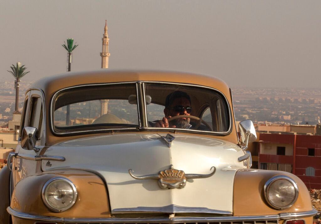 El coleccionista egipcio Mohamed Wahdan conduce un Chrysler 1948 el 1 de marzo de 2022, en la ciudad de Obour, cerca de El Cairo, Egipto. Durante más de 20 años, el empresario de 52 años ha logrado coleccionar una flota de más de 200 coches vintage, antiguos y clásicos. (AP Foto/Amr Nabil)