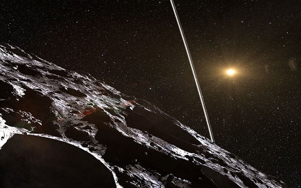 Figura artística. Representación del anillo Chariklo , com podría ser visto desde su superficie. Al fndo se ob serva al Sol iluminando tenuemente al asteroide. Foto: NASA/JPL.