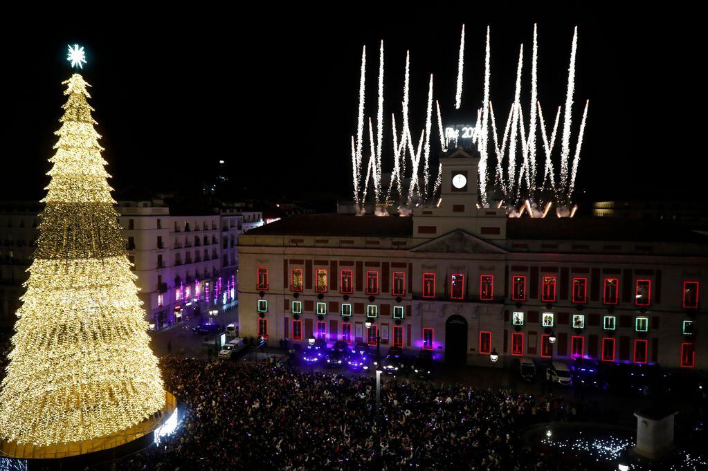 Cientos de personas se reúnen en la Puerta del Sol para recibir con las campanadas de Año Nuevo en Madrid (España). EFE/JP Gandul
