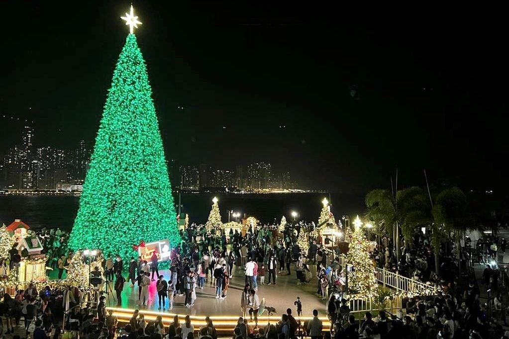 La gente se reunió en la víspera de Navidad en el árbol de Navidad más alto de 20 metros que se encuentra en los bordes del puerto Victoria en Hong Kong.