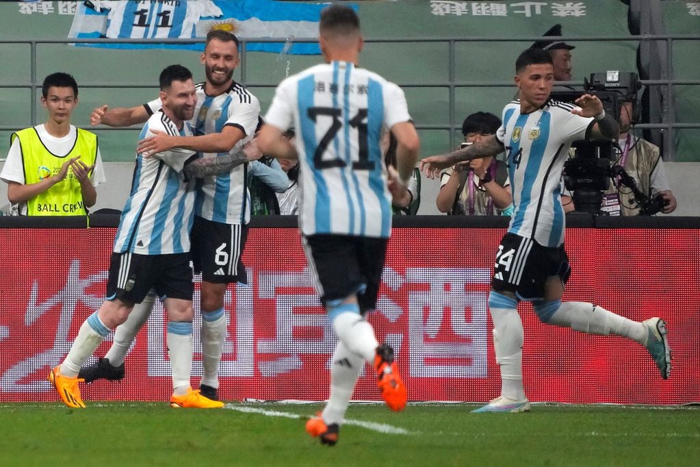 Messi abraza a Pezzella, los goleadores del partido ante Australia en China. / AP