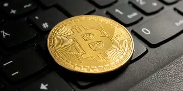 Closeup shot of a bitcoin put on a black computer keyboard