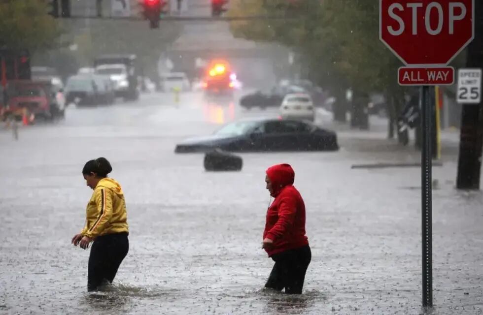 Los residentes caminan a través de las aguas de la inundación en Nueva York, este viernes. Gentileza: CNN.