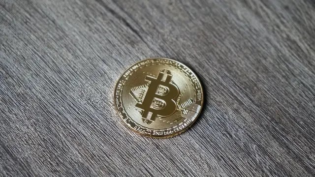 Closeup shot of a bitcoin on a wooden table