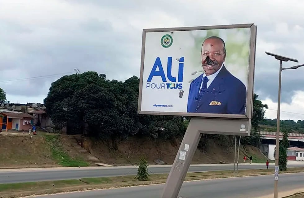 Un cartel roto del presidente de Gabón, Ali Bongo Ondimba, en una calle de Libreville, Gabón, el 30 de agosto de 2023, el mismo día que fue derrocado. (Foto AP/Yves Laurent, archivo)