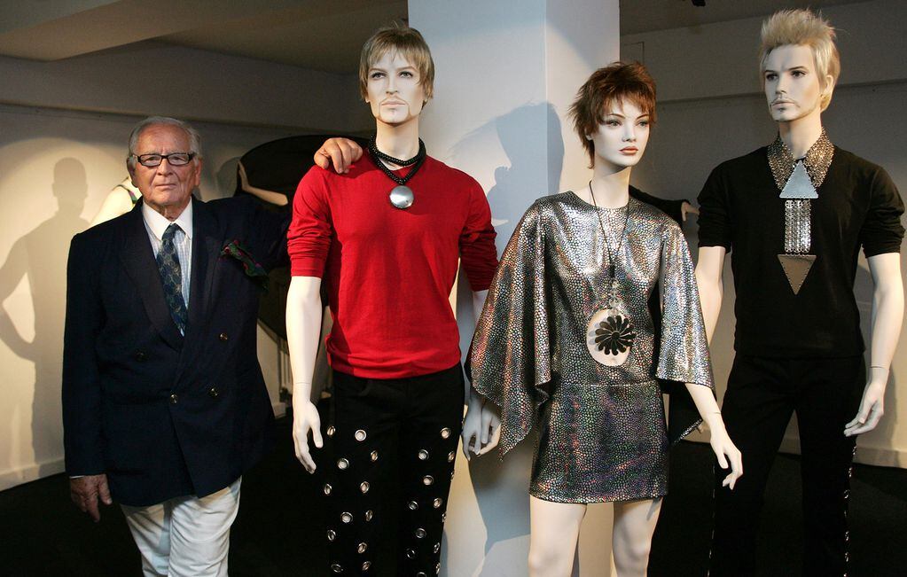 (FILES) This file photo taken on July 4, 2006 shows French designer Pierre Cardin posing with some dummies featuring his Men's 2007 Spring-Summer collection, in Paris. - French fashion designer Pierre Cardin, hailed for his visionary creations but also for bringing stylish clothes to the masses, died on December 29, 2020 aged 98, his family told AFP. Cardin who was born in Italy in 1922 but emigrated to France as a small child, died in a hospital in Neuilly in the west of Paris, his family said. (Photo by PIERRE VERDY / AFP)