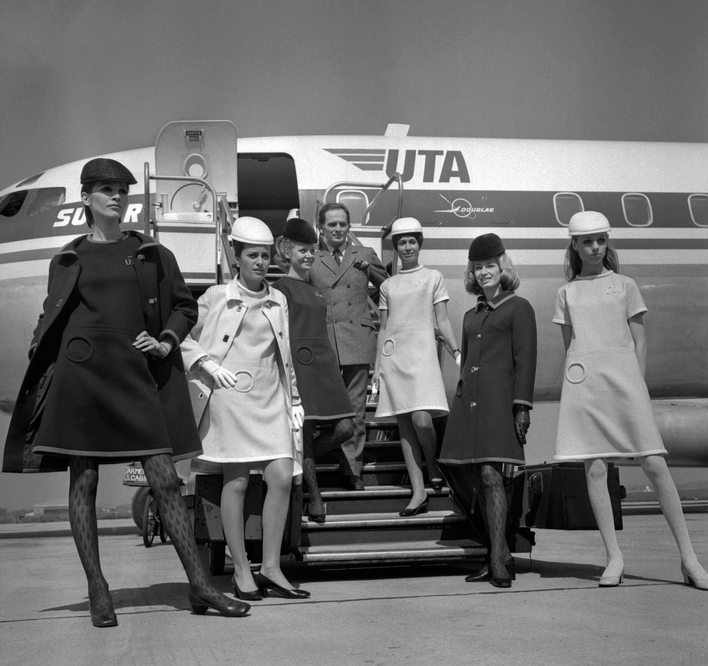 (FILES) This file photo taken on May 9, 1968 shows French designer Pierre Cardin presenting the new uniforms of UTA' s flight attendants, at Le Bourget airport. - French fashion designer Pierre Cardin, hailed for his visionary creations but also for bringing stylish clothes to the masses, died on December 29, 2020 aged 98, his family told AFP. Cardin who was born in Italy in 1922 but emigrated to France as a small child, died in a hospital in Neuilly in the west of Paris, his family said. (Photo by - / AFP)