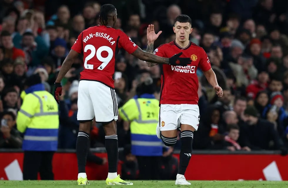 Manchester United's Argentinian defender #06 Lisandro Martinez (R) comes on after several months off injured, during the English Premier League football match between Manchester United and Tottenham Hotspur at Old Trafford in Manchester, north west England, on January 14, 2024.