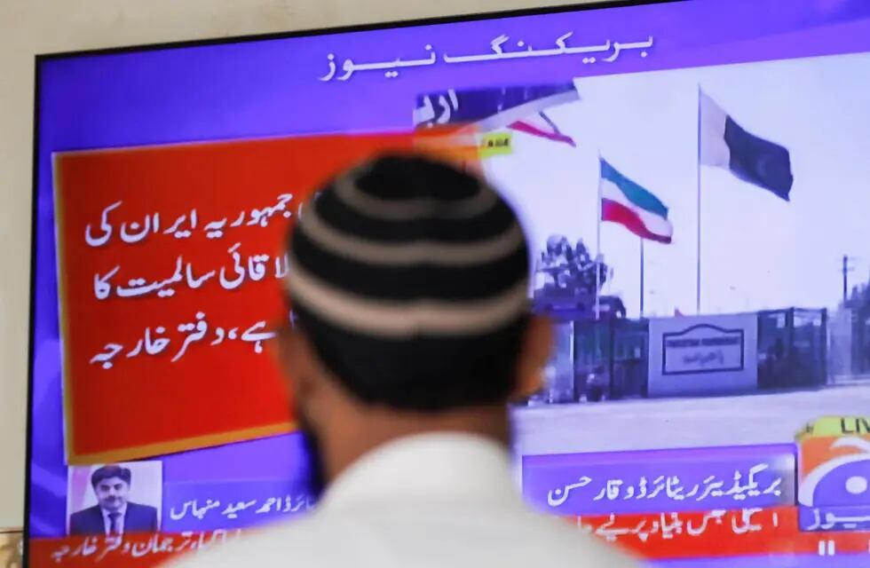 Un hombre mirando las noticias a Pakistán, donde informan del ataque que el país ha lanzado a Irán en represalia por los misiles que recibieron en su territorio del día anterior.