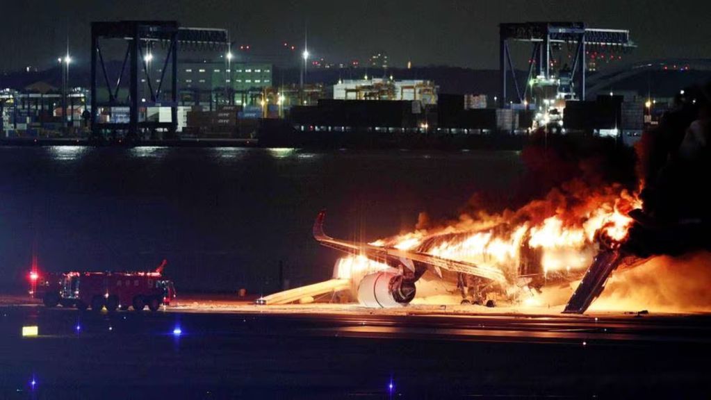 El avion comercial envuelto en llamas tras colisionar con una aeronave de la Guardía Costera