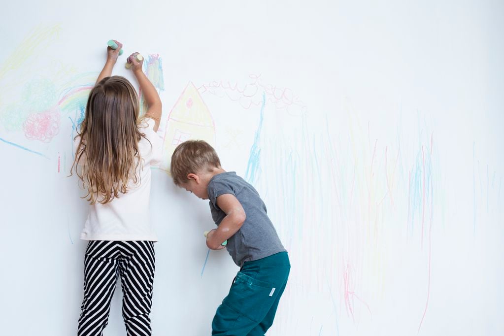 Una niña y un niño, alumnos de la escuela basada en el modelo finlandés, aprenden pintando. Gentileza.