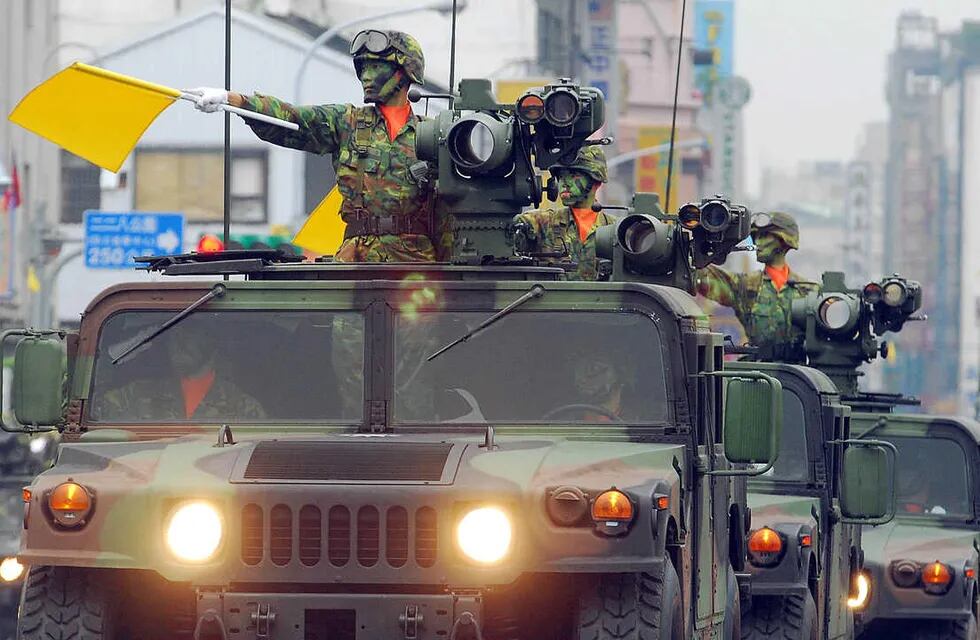A fleet of Taiwanese military vehicles loading US-made TOW anti-tank missiles, run through the Office of President during a rehearsal for National Day celebrations, Monday, Oct. 8, 2007, in Taipei, Taiwan. War planes, armored personnel carriers and other weapon systems will be displayed Wednesday during the National Day military parade. (AP Photo/Chiang Ying-ying)